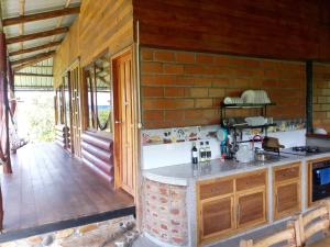 a kitchen with a counter and a brick wall at Rancho San Andrés in Palora