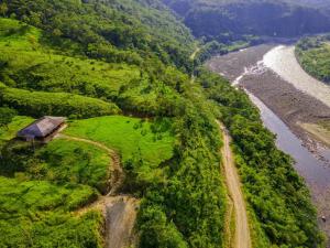 an aerial view of a farm and a river at Rancho San Andrés in Palora