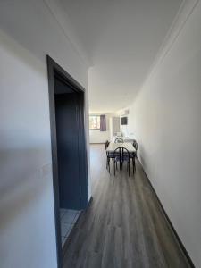 a hallway with a table and a door to a room at Hume Villa Motor Inn UNDER NEW MANAGEMENT in Melbourne