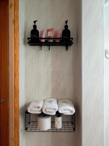 a bathroom with two towels and a shelf with toilets at Playa Sol Vinaròs in Vinarós +19 photos