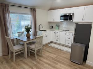 a kitchen with a table and chairs and a refrigerator at Modern Private Studio - Separate Entry in Edgewood