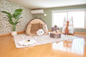 a room with a play tent and toys on a floor at R STAY Nagoya Juocho in Nagoya +65 photos