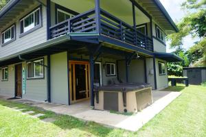 a house with a screened in porch with a grill at Pau Hana Paradise in Hana +3 photos