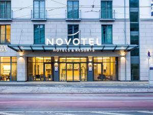 a building with a novation hotel and rooms sign on it at Novotel Nürnberg Centre Ville in Nuremberg