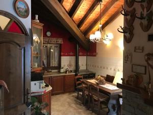 a kitchen with a table and a dining room at La posa sul lago in Rimasco