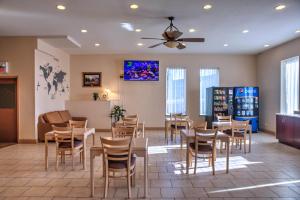 a restaurant with tables and chairs in a room at Lone Star Hotel in North Battleford