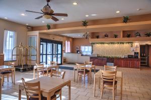 a restaurant with tables and chairs in a room at Lone Star Hotel in North Battleford