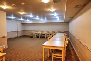 a conference room with tables and chairs in it at Lone Star Hotel in North Battleford
