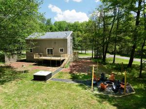 an aerial view of a building in a yard at Tucked in the Woods - Jacuzzi Firepit Pooltable in Long Pond