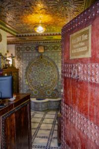 a bathroom with a tub and a sign on a wall at Riad Fes iline Medina in Fez
