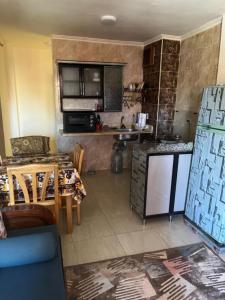 a small kitchen with a table and a counter top at لاسرينا عيون موسي in Az Zaytīyah