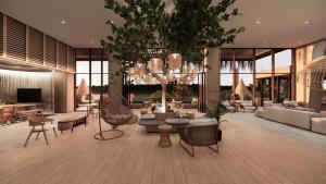 a lobby with couches and chairs and a chandelier at ASAI Gamuda Cove in Banting