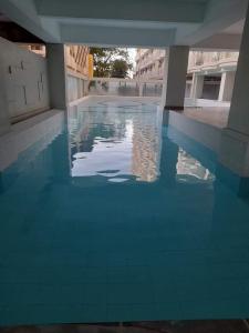 a swimming pool with blue tiles on the floor at Maldee's Place Tagaytay Prime Residences in Tagaytay
