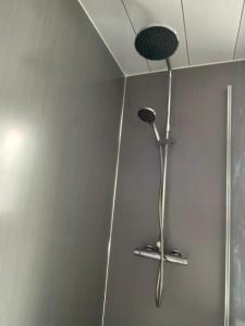 a shower with a shower head in a bathroom at Pure Home Oakley Central TBA in Dunfermline +8 photos