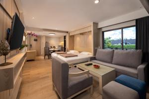 a living room with a couch and a table at Bali Dynasty Resort in Kuta