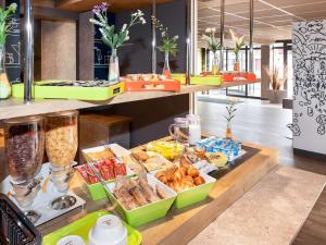 a buffet with different types of food on a table at ibis budget Goussainville Charles de Gaulle in Goussainville