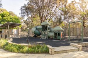 a playground with a slide in a park at Wyndham Resort Torquay in Torquay