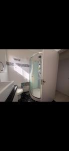 a bathroom with a mirror and a sink and a toilet at Quarto Suíte Master Luxo in Santana do Livramento