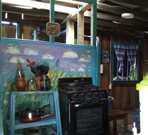 a kitchen with a stove and a painting on the wall at Kismet Inn Semi Private in Hopkins