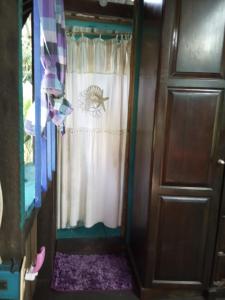 a door leading into a room with a curtain at Kismet Inn Semi Private in Hopkins