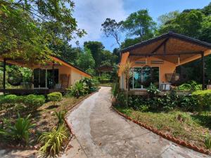 a house with a pathway next to a building at Samloem Laguna Resort in Koh Rong Sanloem +21 photos