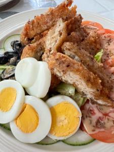 a plate of food with eggs and other vegetables at The Sanctuary in El Nido