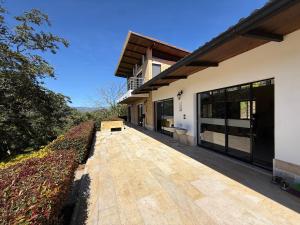 an external view of a house with a wooden walkway at Casa - Finca Villa Violeta in San Vicente