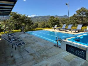 a swimming pool with lounge chairs and a swimming pool at Casa - Finca Villa Violeta in San Vicente