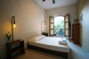 a bedroom with a large bed and a window at Puerto Dreams H in Puerto Escondido