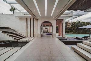an empty lobby of a house with a swimming pool at Nara Villa Canggu by Ini Vie Hospitality in Canggu +23 photos