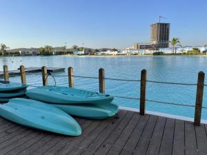 a group of boats sitting on a dock next to the water at Mazablue, alberca más grande de México in Mazatlán