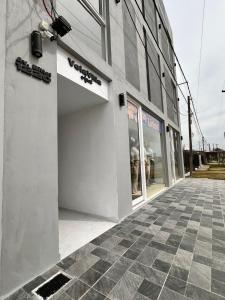a store front of a building with a sign on it at Vela Villa Apart N3 in Villa Ángela