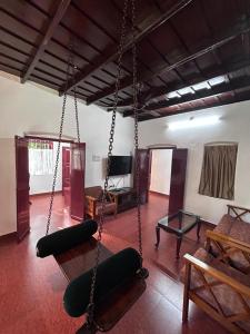 a room with two swings in a room at Remasailam Homestay - Thiruvananthapuram , Calm & Blend with Nature in Trivandrum