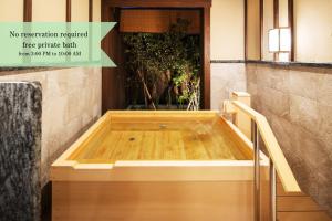 a jacuzzi tub in the corner of a room at La Vista Minami Aso Grand opening October 2nd 2026 in Minami Aso