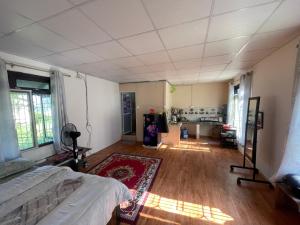 a large room with a bed and a red rug at Organic Retreats in Pokhara