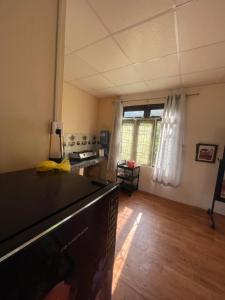 a living room with a desk and a large window at Organic Retreats in Pokhara