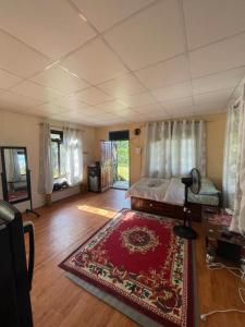 a bedroom with a bed and a rug in a room at Organic Retreats in Pokhara
