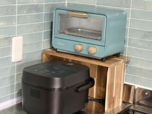 a toaster oven sitting on top of a counter at Tasogare in Kihokucho