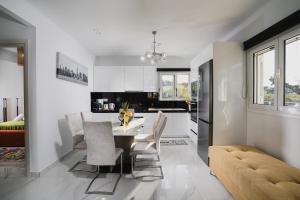a kitchen and dining room with a table and chairs at Moonlit Villa in Planos