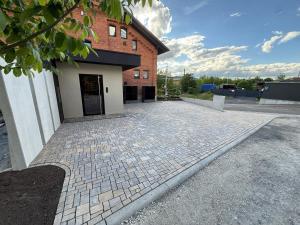 a brick building with a cobblestone driveway in front of it at Gleisbett 12-2 in Meiningen +6 photos
