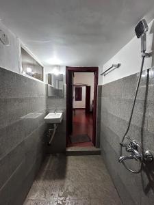 a bathroom with a sink and a shower at Remasailam Homestay - Thiruvananthapuram , Calm & Blend with Nature in Trivandrum +28 photos