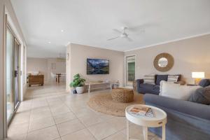 a living room with a couch and a table at Noosa Sunrise - Pet-friendly with Pool in Sunrise Beach