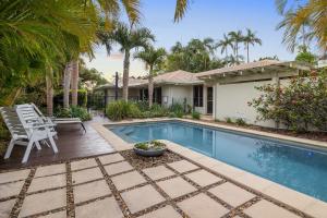 a backyard with a swimming pool and a house at Noosa Sunrise - Pet-friendly with Pool in Sunrise Beach +7 photos