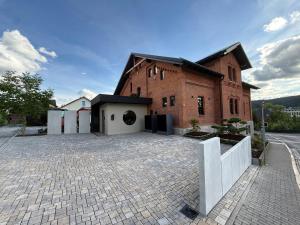 a brick building with a white fence in front of it at Gleisbett 12-3 in Meiningen