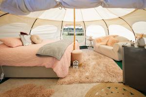 a bedroom with a bed in a tent at Bukirk Glamping & Luxury Cabins - Clare Valley in Clare +61 photos