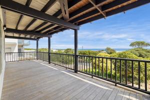 an outdoor deck with a view of the ocean at Grandview Holiday Beach House in Gracetown