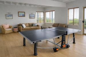 a ping pong table in a living room at Grandview Holiday Beach House in Gracetown