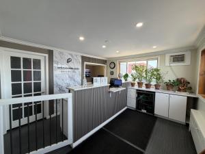 a large kitchen with white cabinets and a counter at Perth Plaza Inn & Suites in Perth