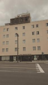 a large white building on the side of a street at 水戸第一ホテル本館 in Mito