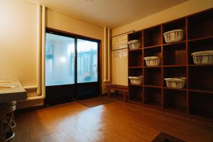 a room with a door and shelves with baskets at ZAO SPA HOTEL Kiraku in Zaō Onsen